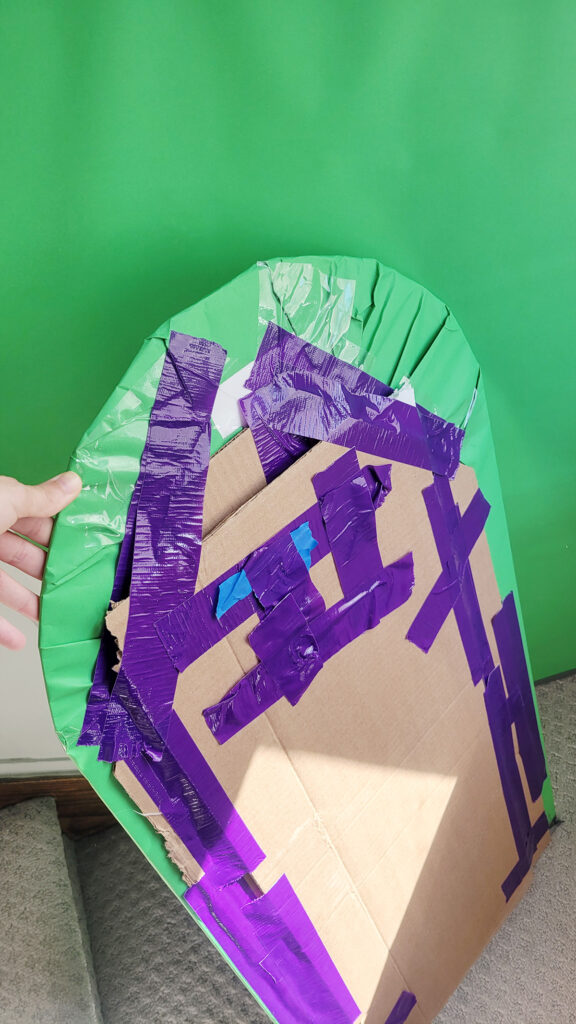 Tape and structure behind a flat green hill